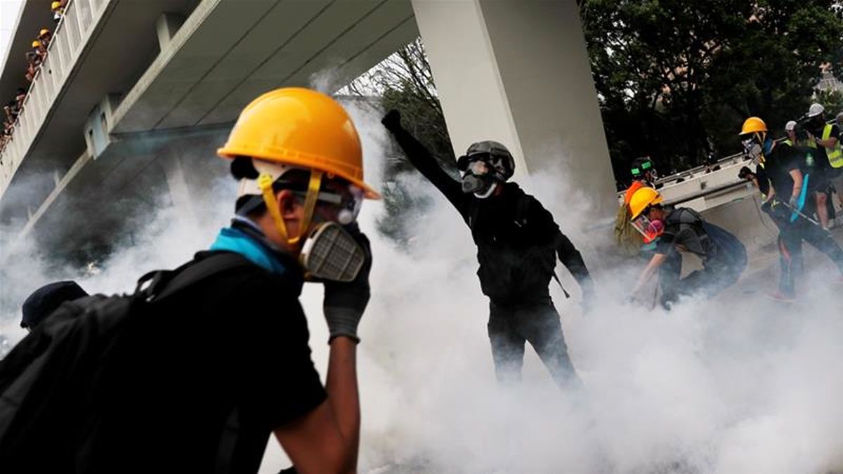 Hong Kong leader urges calm as protest tensions rise; airport reopens